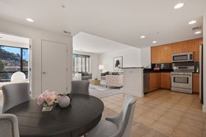 Novato apartment for rent - Novato CA Apartments with In-Unit Washer and Dryer - Millworks - Dining Area with Table, Chairs, High Ceiling with Recessed Lighting, and View of Kitchen and Living Area.