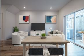 Vancouver apartment for rent - Apartments Near Vancouver Mall, WA - Minnehaha Meadows - Living Room with Vinyl Plank Flooring, Couch, Armchairs, Media Cabinet, TV, Side Table, Lamp, Framed Artworks, and a Sliding Door to the Patio.