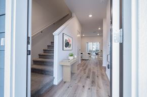 Vancouver apartment for rent - A hallway with a staircase and a painting on the wall.