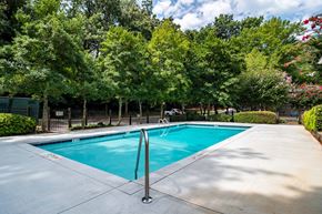 Clarkston apartment for rent - Sparkling outdoor swimming pool surrounded by trees at Mirador at Idlewood Apartments near Edgewood and Kirkwood
