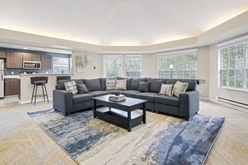 Bothell apartment for rent - A modern living room with a grey sofa and a coffee table.