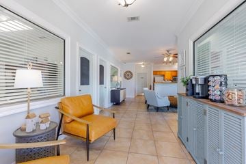 Biloxi apartment for rent - A living room with a yellow chair and a grey cabinet.