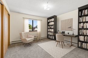 Coon Rapids apartment for rent - a home office with two chairs and a desk and a window