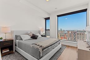 Portland apartment for rent - a bedroom with a large window and a large bed