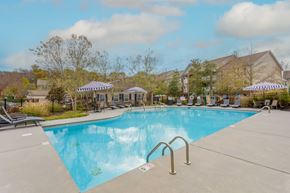 Sevierville apartment for rent - One, Two and Three- Bedroom Apartments for Rent in Sevierville, TN – Overlook at Allensville – A large swimming pool with seating areas and umbrellas
