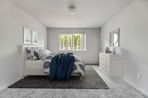 Vancouver apartment for rent - Vancouver, WA, Apartments with In-Unit Washer and Dryer - Prairie Home Apartments - Bedroom with Carpet Flooring, Ceiling Light, Bed, Dresser, Mirror, Framed Photos, and Windows.