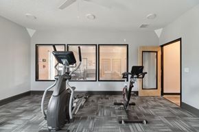 Vancouver apartment for rent - A gym with a treadmill, elliptical trainer and a stationary bike.