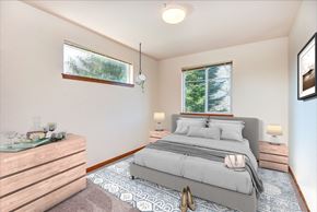 Olympia apartment for rent - a bedroom with a bed and two windows