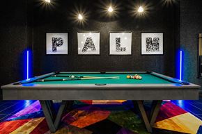 Las Vegas apartment for rent - a pool table in a billiards room with pictures on the wall