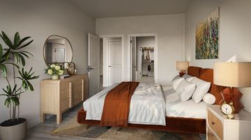Dallas apartment for rent - A bedroom with a large bed and a plant.