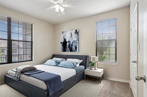 Maumelle apartment for rent - 1, 2 & 3-Bedroom Apartments for Rent in Maumelle, AR – Parc at Maumelle – A bedroom with a large bed and a ceiling fan.