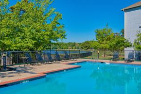 Maumelle apartment for rent - Pet-Friendly Rentals in Maumelle, AR – Parc at Maumelle – a swimming pool surrounded by trees and beach chairs