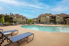 Rogers apartment for rent - Apartments for Rent in Rogers, AR 72758– Parc at Rogers-   Swimming pool surrounded by apartments and beach chairs