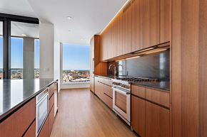 Portland apartment for rent - a kitchen with wooden cabinets and a large window