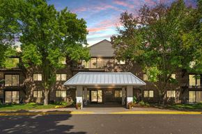 Golden Valley apartment for rent - Laurel West End Apartments in Golden Valley, MN photo of a large building with trees in front of it