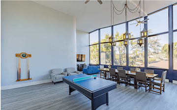 El Cajon apartment for rent - an open living room with a ping pong table and a dining room with chairs