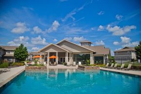 Raymore apartment for rent - A large house with a pool in front.