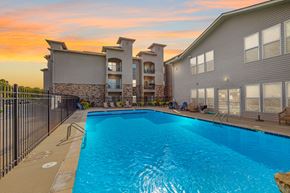 Grain Valley apartment for rent - our apartments have a large swimming pool with a sunset in the background