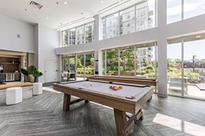Stamford apartment for rent - A pool table in a room with a view of the city.