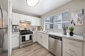 Colton apartment for rent - an open kitchen with stainless steel appliances and white cabinets