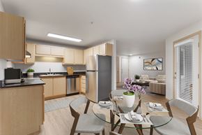 Vancouver apartment for rent - A modern kitchen with a dining table set for two.