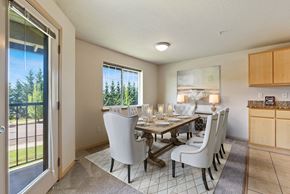 Vancouver apartment for rent - a dining room with a table and chairs and a sliding glass door