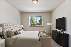 Vancouver apartment for rent - a bedroom with a large bed and a large window