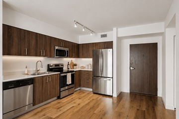 Miami apartment for rent - A kitchen with wooden cabinets and stainless steel appliances.