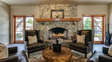 Coeur D Alene apartment for rent - a living room with a stone fireplace and leather furniture