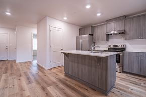 Vancouver apartment for rent - a kitchen with white walls and a wooden floor