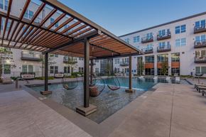 Dallas apartment for rent - Pet-Friendly Apartments in Downtown Dallas, TX- 4600 Ross- Sparkling Pool with Swinging Chairs and Poolside Couches