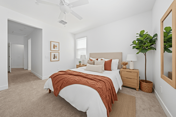 Surprise apartment for rent - A bedroom with a bed, nightstand, and a plant.