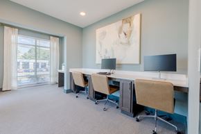 Norcross apartment for rent - A room with a desk and chairs with a painting on the wall.