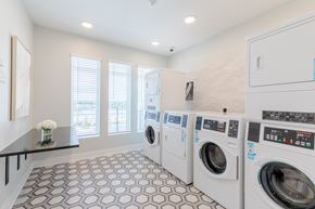 Norcross apartment for rent - A laundry room with a row of washers and dryers.