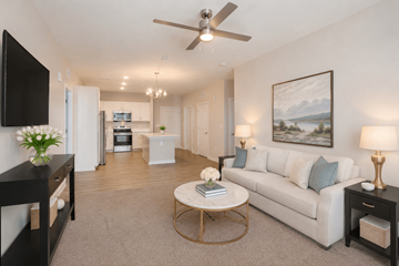 Norcross apartment for rent - A living room with a white couch, a coffee table, and a painting on the wall.