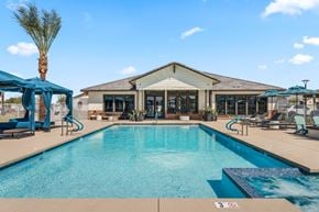 Phoenix apartment for rent - A large swimming pool with a building in the background.
