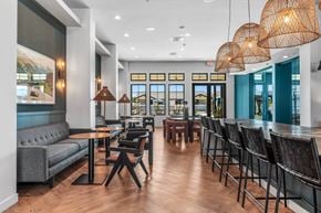Phoenix apartment for rent - A modern dining area with wooden floors and black chairs.