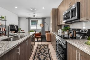 Phoenix apartment for rent - A modern kitchen with a sink, stove, and microwave.