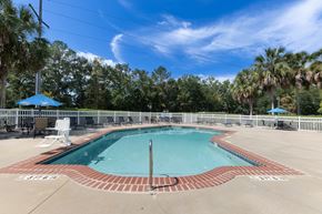 Tallahassee apartment for rent - Resort-style pool with outdoor seating at Savannah Sound pet-friendly apartments in Tallahassee FL