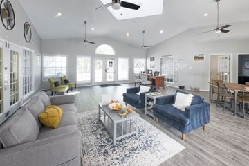 Tallahassee apartment for rent - A living room with a grey couch and a blue couch.