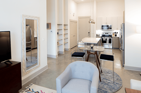 Dallas apartment for rent - A modern kitchen with a blue chair in the middle of the room.
