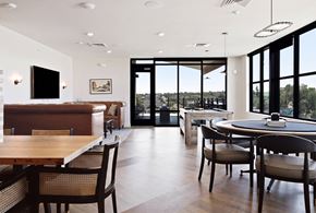 Greeley apartment for rent - A modern dining room with a wooden table and chairs.