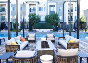 Las Vegas apartment for rent - A poolside seating area with a variety of cushions and chairs.