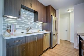 Belmont apartment for rent - A kitchen with wooden cabinets and a stone backsplash.