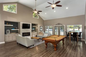 Stockbridge apartment for rent - A spacious living room with a pool table and a fireplace.
