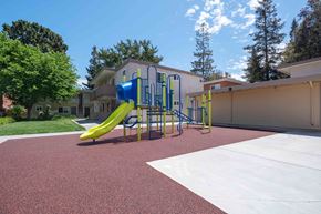 Milpitas apartment for rent - Two-Bedroom Apartments in Milpitas, CA - Spring Valley Apartments - Playground With Blue And Green Slide Structure On Rubber Surface, And Surrounded By Trees.