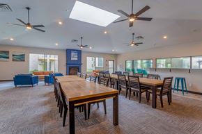 Fridley apartment for rent - a large dining room with tables and chairs and a fireplace