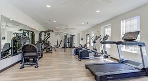 Flagstaff apartment for rent - A spacious gym with a variety of equipment including treadmills, stationary bikes, and weight machines.