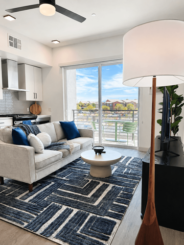 Las Vegas apartment for rent - A living room with a white couch and a black and white rug.