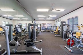 Addis apartment for rent - Sugar Mill Apartments in Addis, LA photo of a gym with cardio equipment and weights in a building with windows